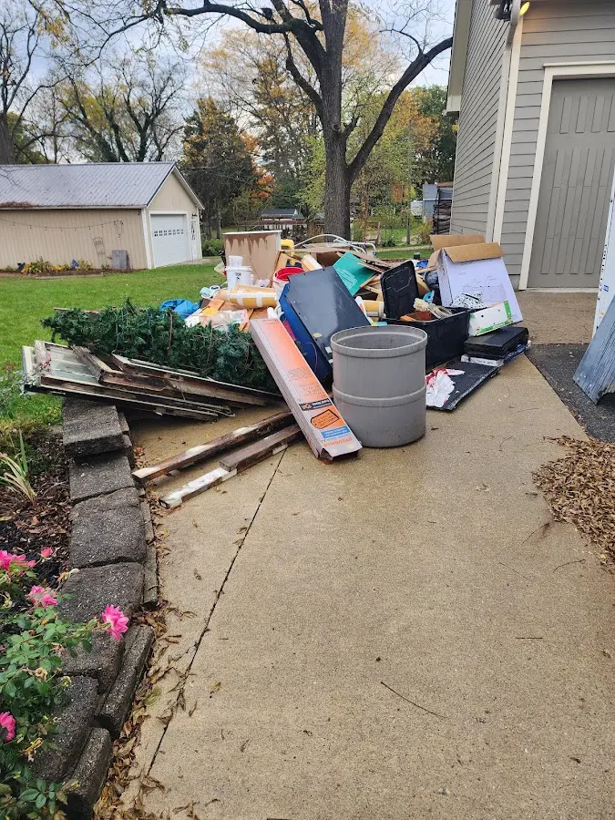 Dumpster being loaded with debris for Commercial Dumpster Rental in Livingston